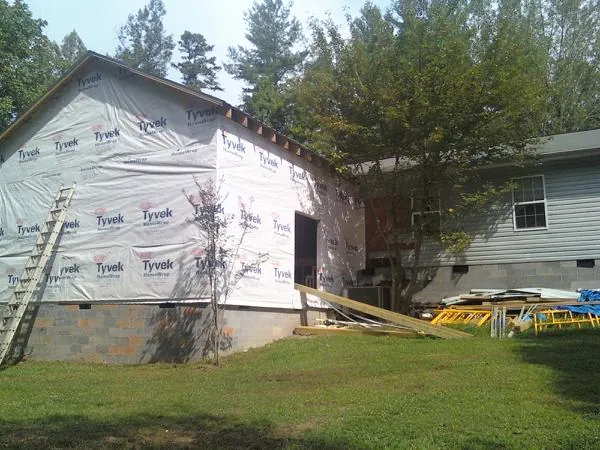 Tyvek wrapped gable on a new room addition beside an existing home in Lees Summit